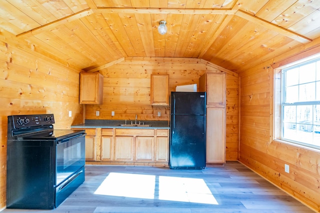 kitchen featuring black appliances, light brown cabinetry, wooden walls, and vaulted ceiling