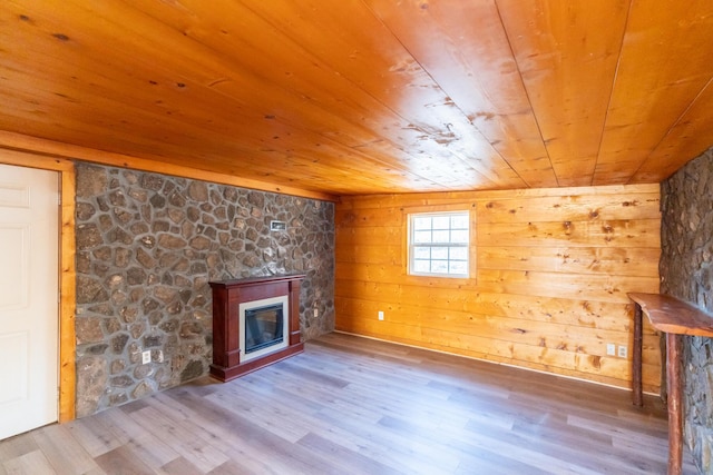 unfurnished living room featuring hardwood / wood-style flooring, wood walls, and wood ceiling