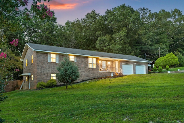 view of front facade with a lawn and a garage