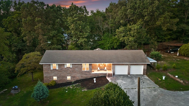 view of front of property with a garage and a yard