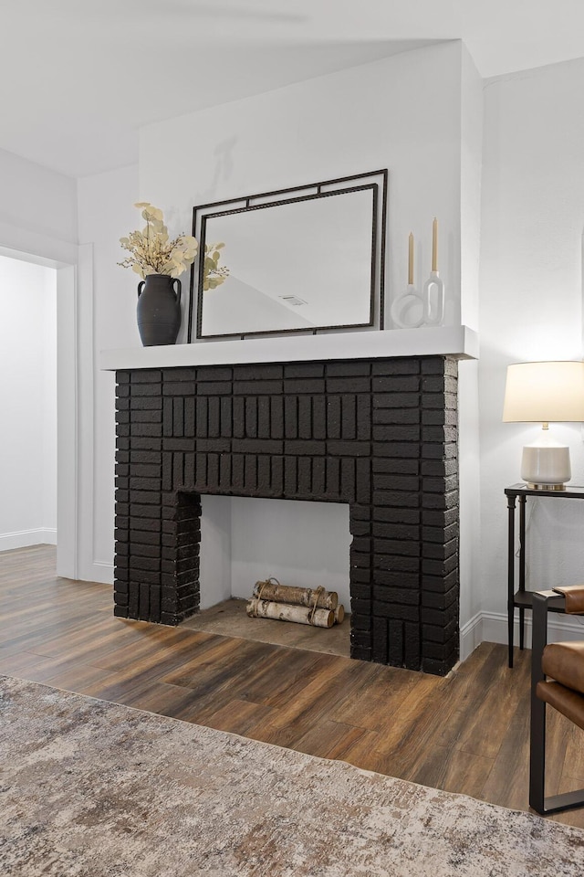 interior details with a fireplace and wood-type flooring