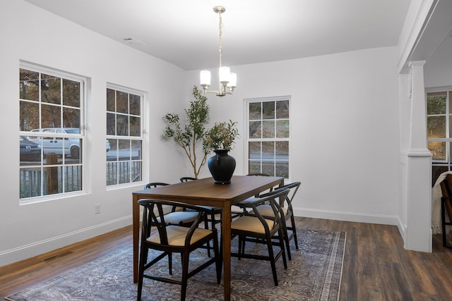 dining room with a chandelier and dark hardwood / wood-style flooring