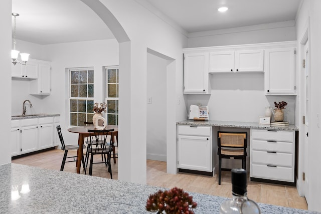 kitchen featuring white cabinets, light hardwood / wood-style flooring, and sink