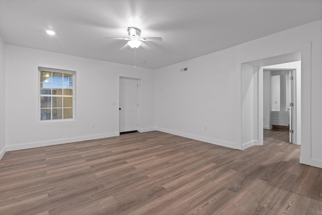 unfurnished room with ceiling fan and hardwood / wood-style floors