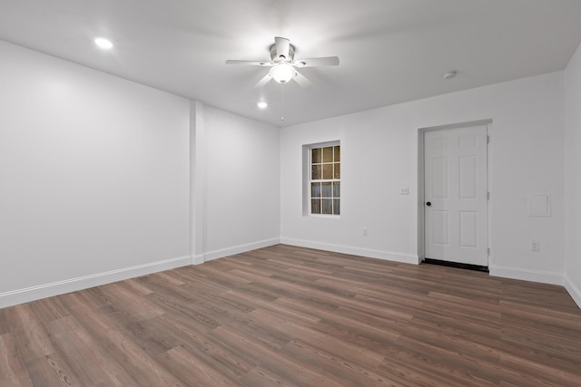 spare room with dark hardwood / wood-style floors and ceiling fan