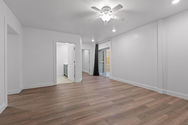 empty room featuring ceiling fan and light hardwood / wood-style floors