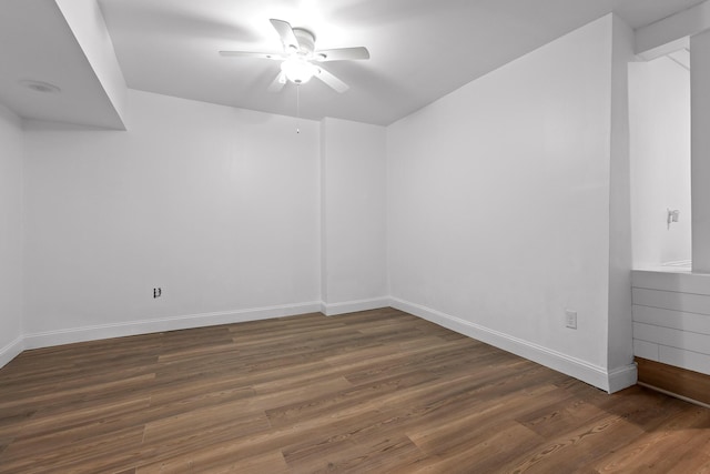 spare room featuring ceiling fan and dark wood-type flooring