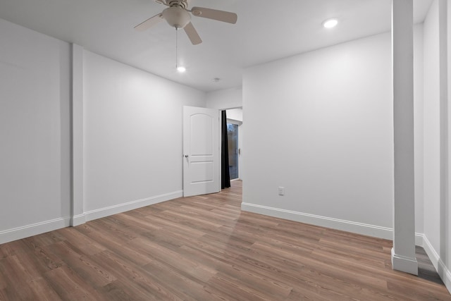 empty room featuring hardwood / wood-style flooring and ceiling fan