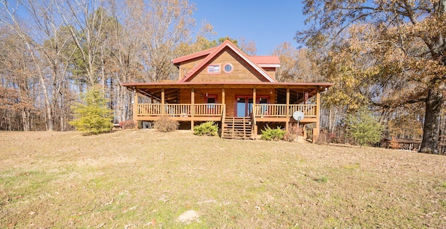 view of front of home featuring a front lawn and metal roof