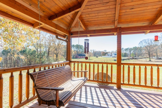 wooden terrace featuring a yard