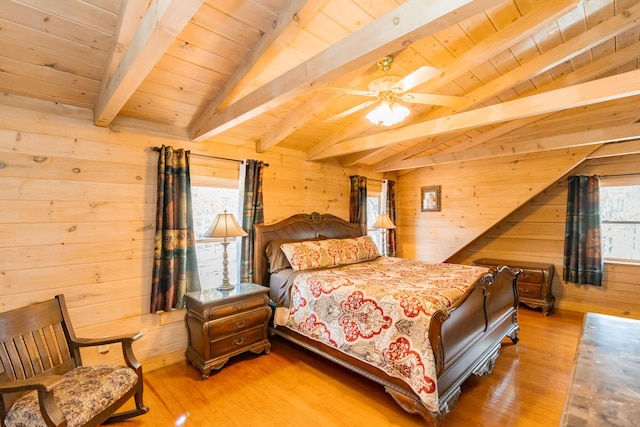 bedroom with lofted ceiling with beams, multiple windows, and wooden walls