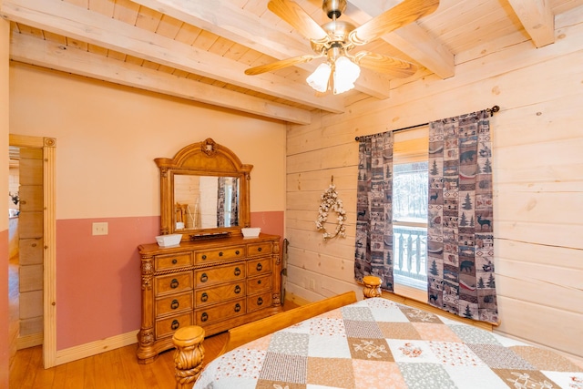 bedroom with wooden walls, wood finished floors, ceiling fan, wood ceiling, and beamed ceiling