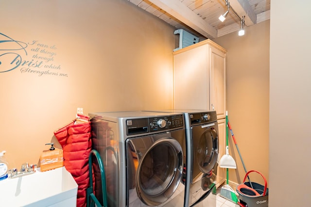 laundry room featuring tile patterned flooring, washing machine and dryer, wooden ceiling, cabinet space, and a sink