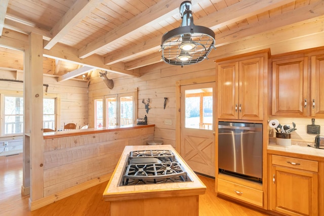 kitchen with light wood-type flooring, black gas stovetop, wooden walls, wooden ceiling, and light countertops