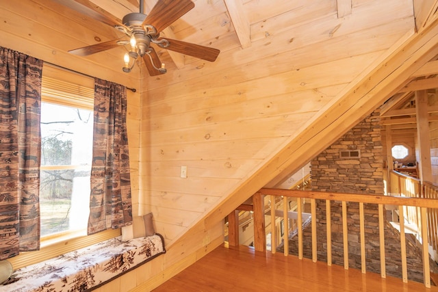 additional living space featuring vaulted ceiling with beams, wood ceiling, wooden walls, and wood finished floors