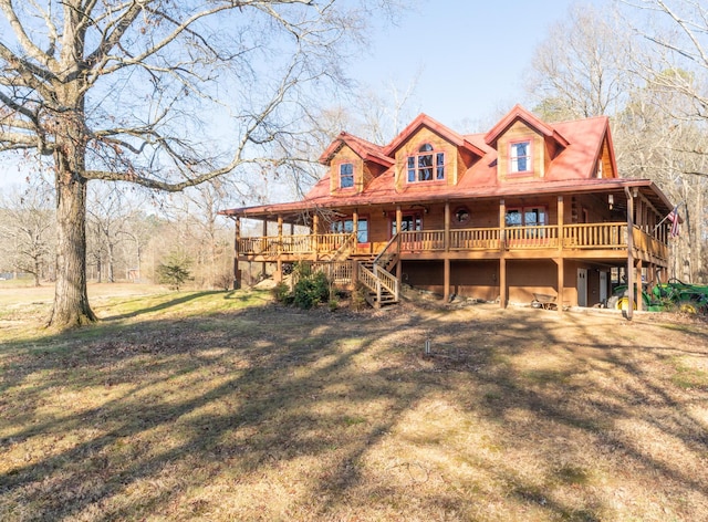 rear view of house featuring a yard and a deck