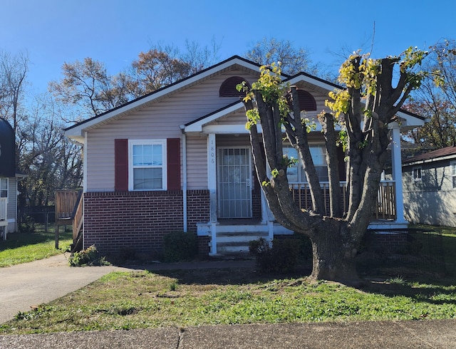 bungalow featuring brick siding