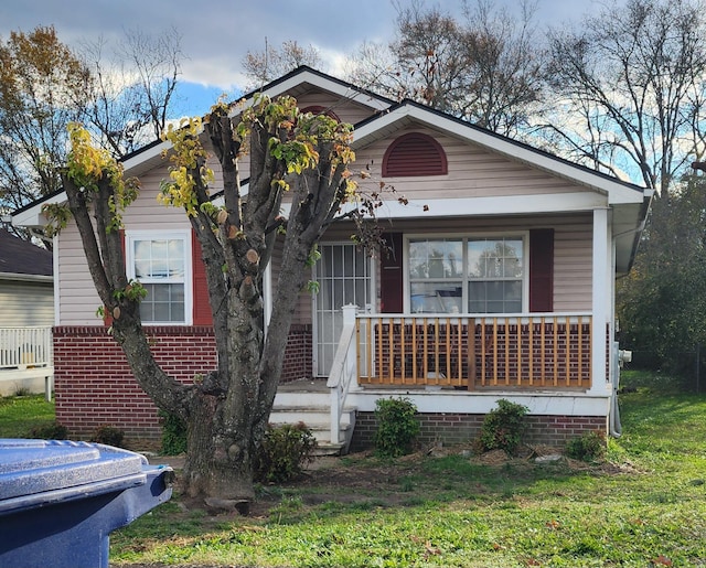 bungalow-style home with a porch and a front yard