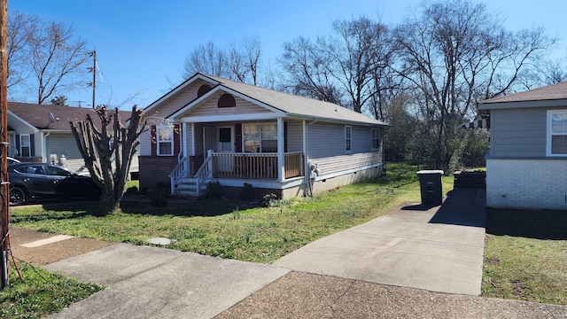 view of front of home with covered porch, crawl space, and a front yard