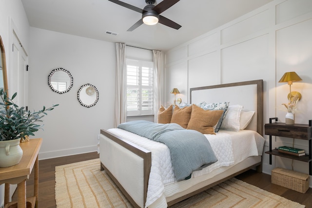 bedroom with ceiling fan and dark hardwood / wood-style floors