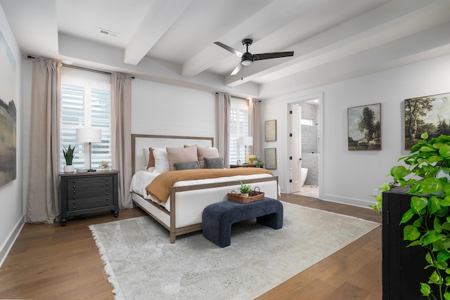 bedroom featuring hardwood / wood-style flooring, ensuite bathroom, and multiple windows