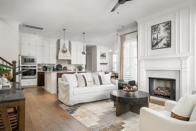 living room featuring hardwood / wood-style floors and ceiling fan