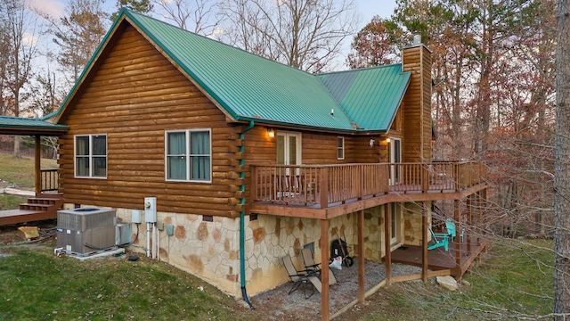 rear view of house with central AC and a deck