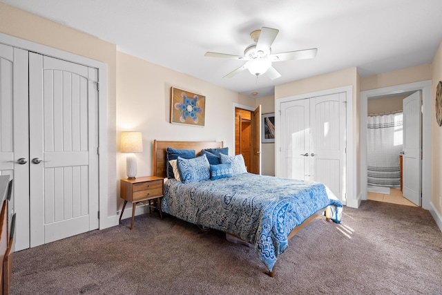 carpeted bedroom featuring ceiling fan and multiple closets