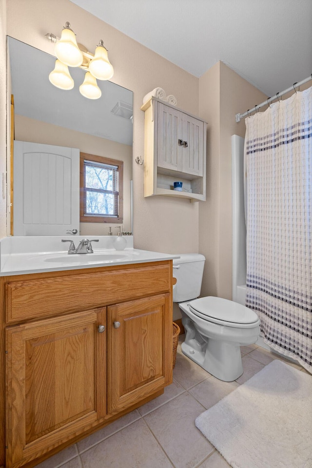 bathroom with tile patterned flooring, vanity, toilet, and curtained shower