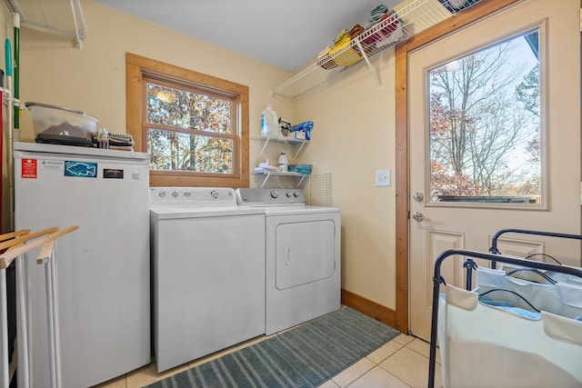 laundry room with separate washer and dryer and light tile patterned flooring