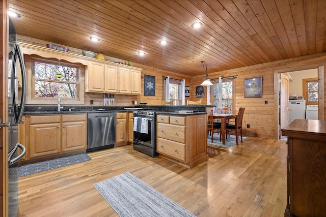 kitchen with kitchen peninsula, stainless steel dishwasher, pendant lighting, black range with electric stovetop, and wood walls