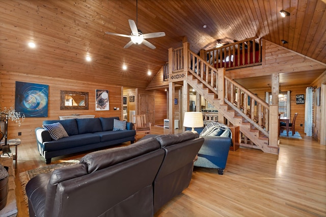 living room with wood walls, ceiling fan, wooden ceiling, and light wood-type flooring