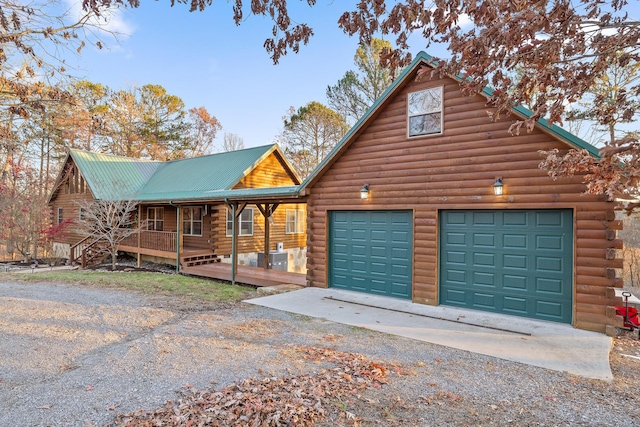 log home featuring covered porch