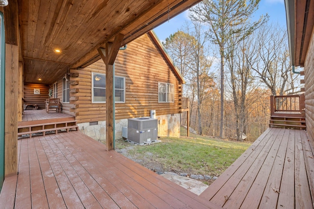 wooden terrace featuring central AC and a lawn