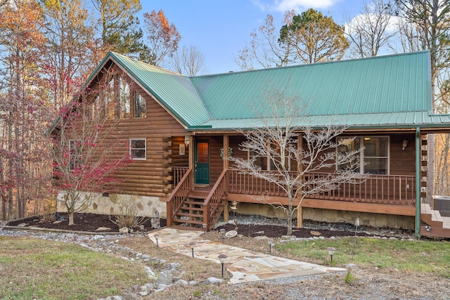 log home featuring a porch