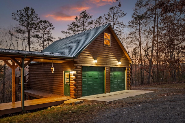 view of garage at dusk