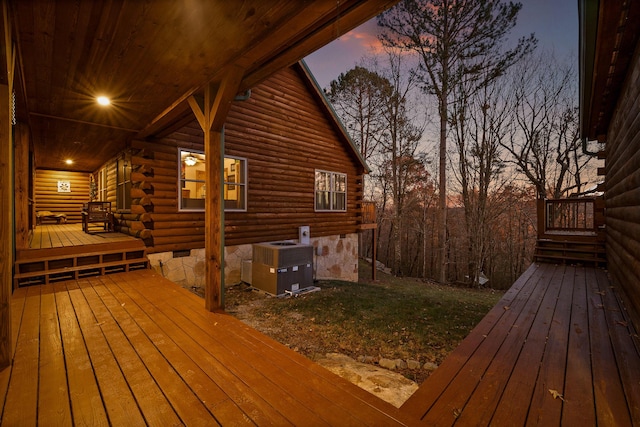 deck at dusk featuring central AC unit