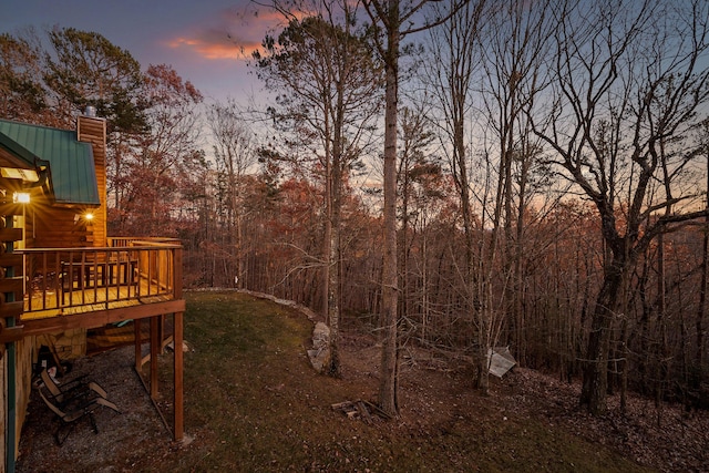 yard at dusk with a wooden deck