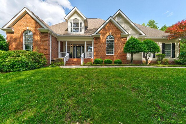 front of property featuring covered porch and a front yard