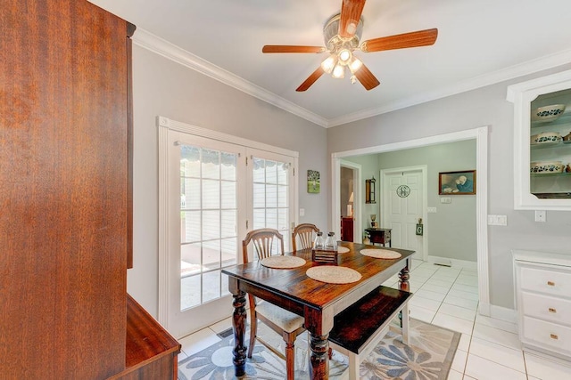 dining space featuring french doors, ceiling fan, crown molding, and light tile patterned flooring