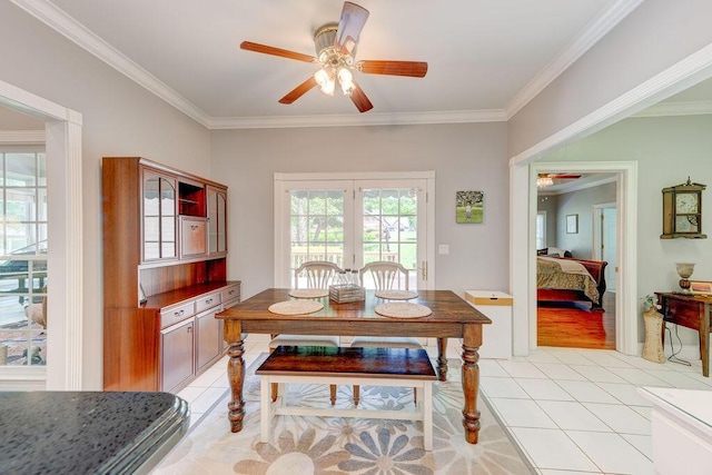 tiled dining area with french doors, ceiling fan, and ornamental molding