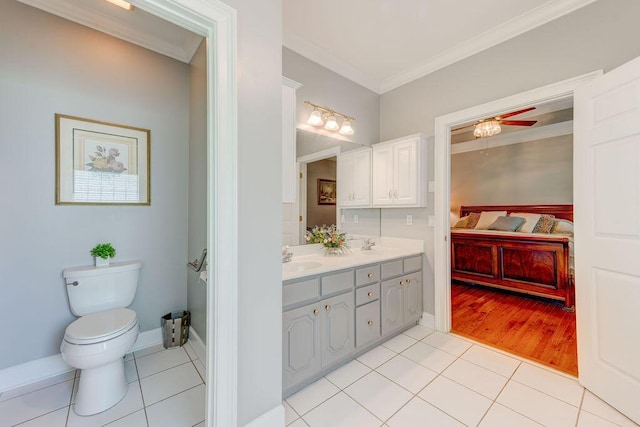 bathroom featuring ceiling fan, tile patterned flooring, toilet, vanity, and ornamental molding