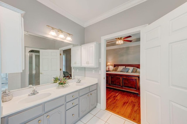 bathroom featuring walk in shower, ornamental molding, vanity, ceiling fan, and hardwood / wood-style flooring