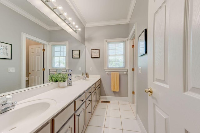 bathroom featuring tile patterned floors, vanity, crown molding, and a healthy amount of sunlight