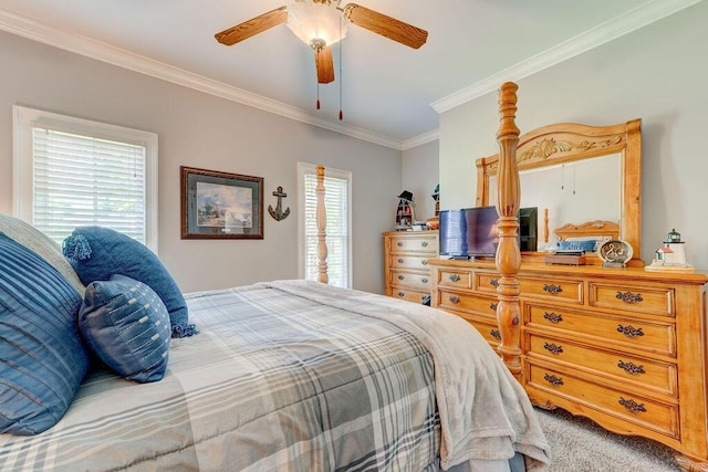 carpeted bedroom featuring ceiling fan and crown molding