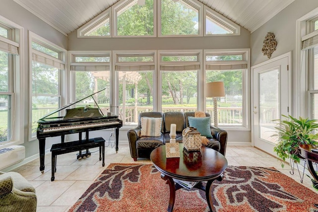 sunroom / solarium with a wall mounted air conditioner, a healthy amount of sunlight, and vaulted ceiling