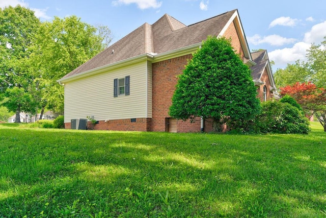 view of side of property with a lawn and central air condition unit