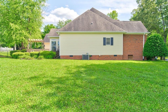 view of property exterior with a yard and central air condition unit