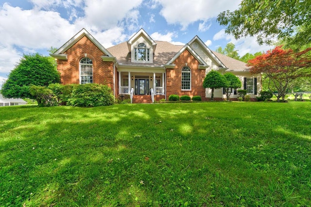 view of front property featuring covered porch and a front lawn