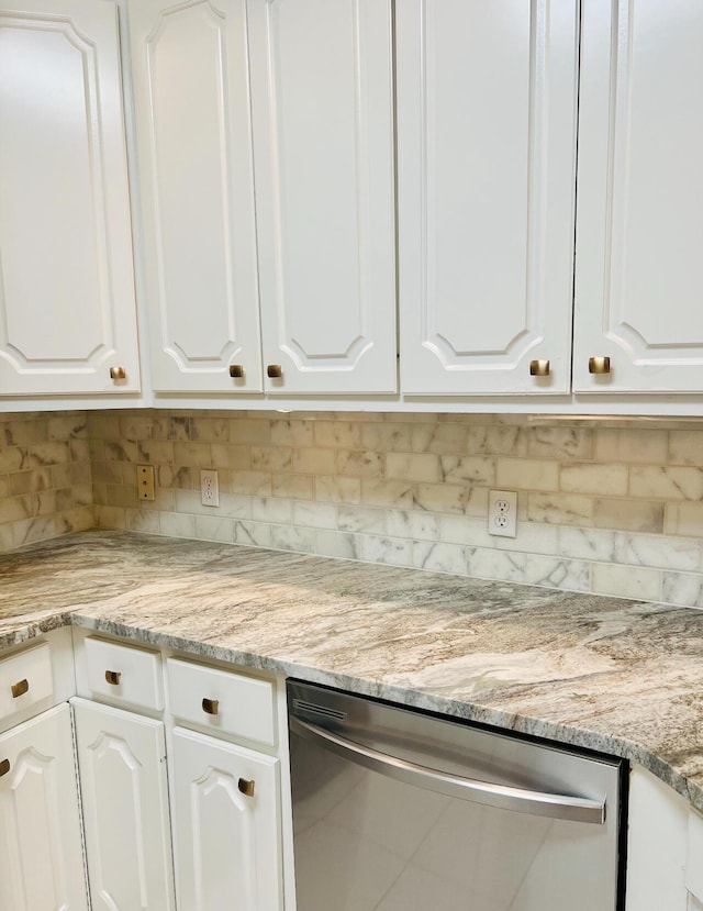 kitchen featuring dishwasher, decorative backsplash, and white cabinets